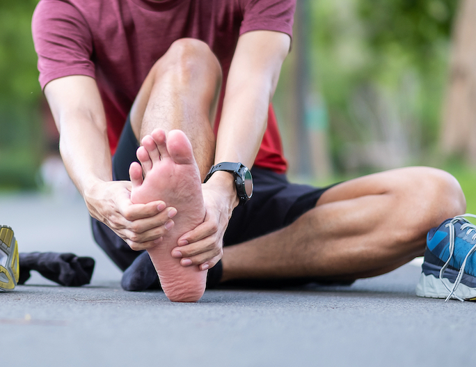 man having heel pain from plantar fasciitis after walking