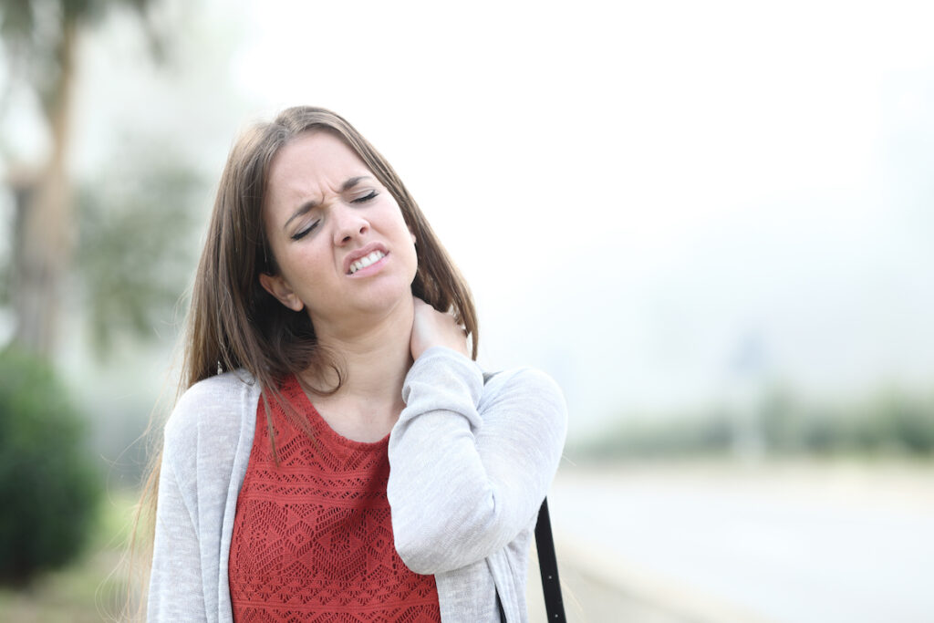 woman suffering from fibromyalgia while walking