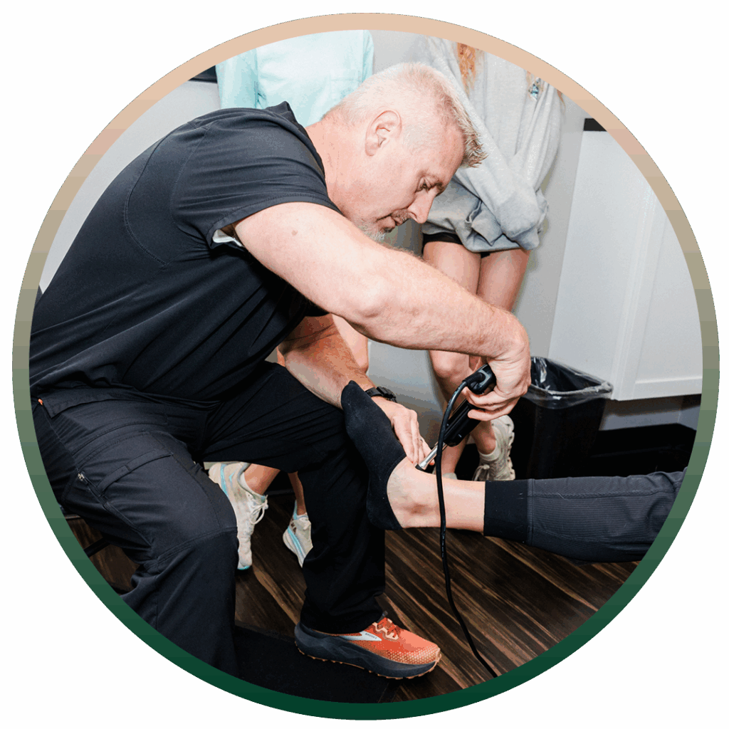 Dr. Cory Powers giving patient leg pain treatment