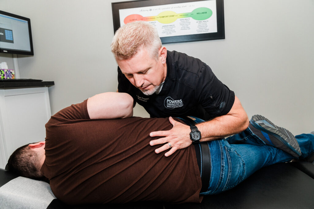 Dr Cory Powers giving his patient hip pain treatment